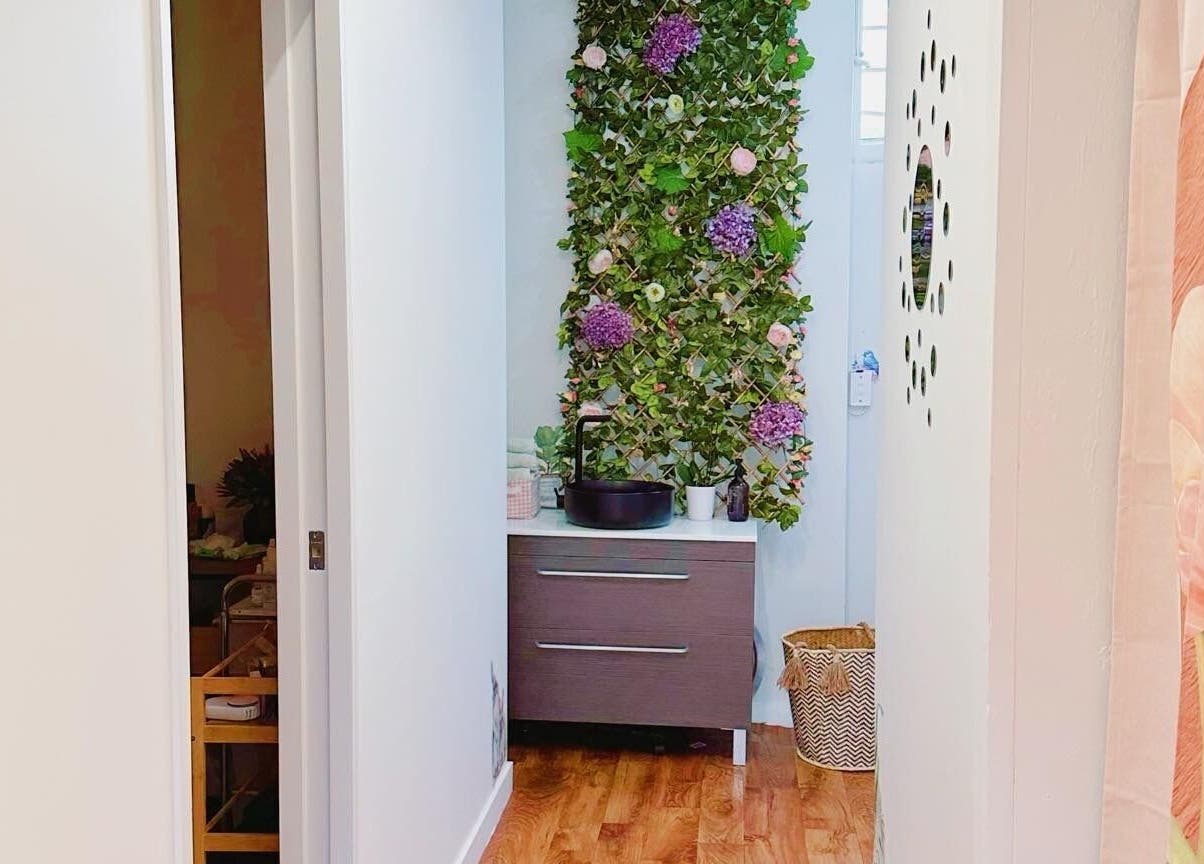 Tranquil hallway at My Nail & Beauty in Christchurch, Canterbury, NZ with floral wall and elegant decor.