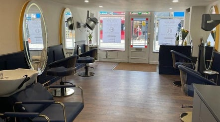 Spacious interior of Greenwich Hair Salon with modern chairs and large mirrors, London, England, GB.