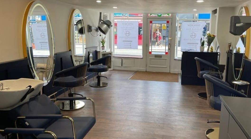 Spacious interior of Greenwich Hair Salon with modern chairs and large mirrors, London, England, GB.