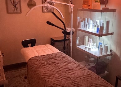 Cozy treatment room at Zen Beauty Lounge LLC in Stroudsburg, Pennsylvania, US with a massage table and skincare products.