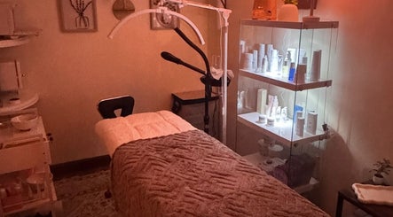 Cozy treatment room at Zen Beauty Lounge LLC in Stroudsburg, Pennsylvania, US with a massage table and skincare products.