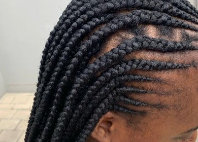 Stylish braids at Touch by Thato Fourways in Sandton, Gauteng, ZA, showcasing intricate cornrow design.