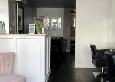 Modern salon interior at Rosie Baylis Hair, Tunbridge Wells, England, GB, featuring chic chairs and a welcoming atmosphere.