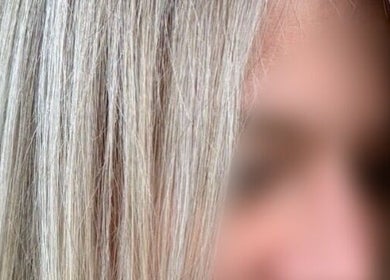 Close-up of sleek, blonde hair at Rosie Baylis Hair in Tunbridge Wells, England, GB.