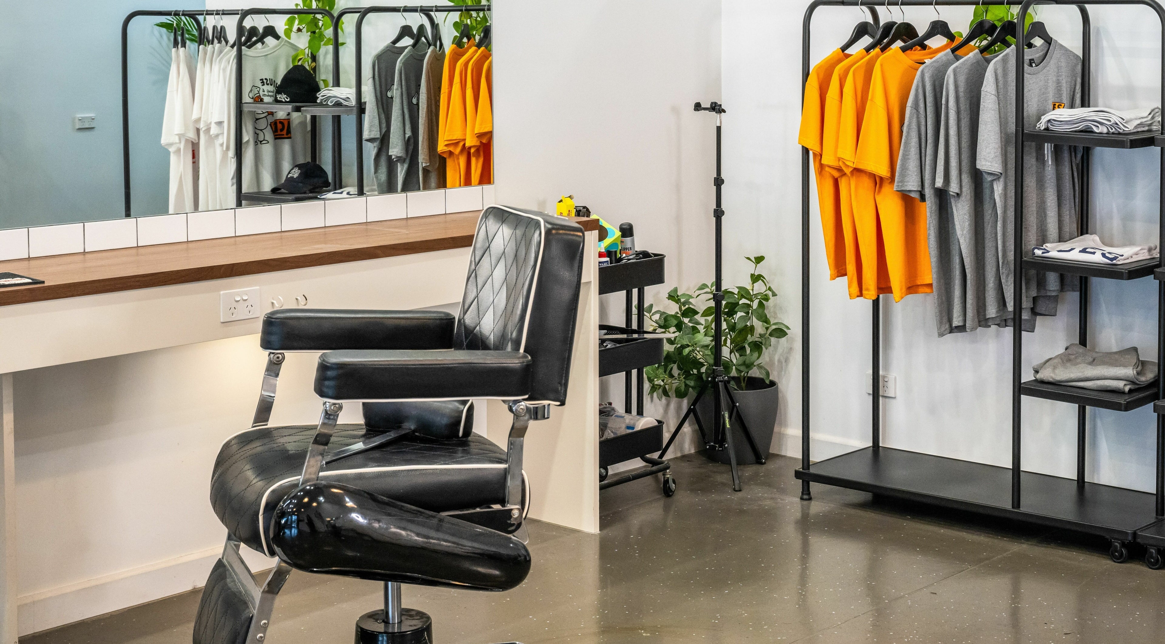 Modern barber chair and apparel display at Aces Barbershop, Ashwood, Victoria, AU.