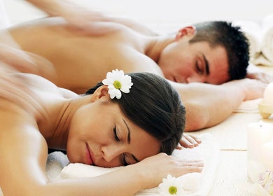 Couple enjoying massage at Best Massage Bali, Canggu, Indonesia, ID amidst soothing ambiance and candles.