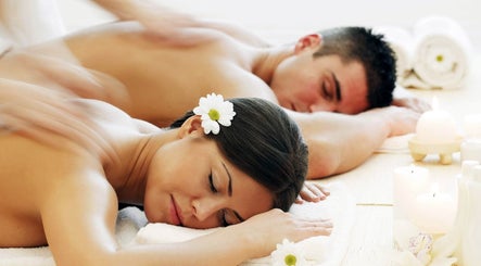 Couple enjoying massage at Best Massage Bali, Canggu, Indonesia, ID amidst soothing ambiance and candles.