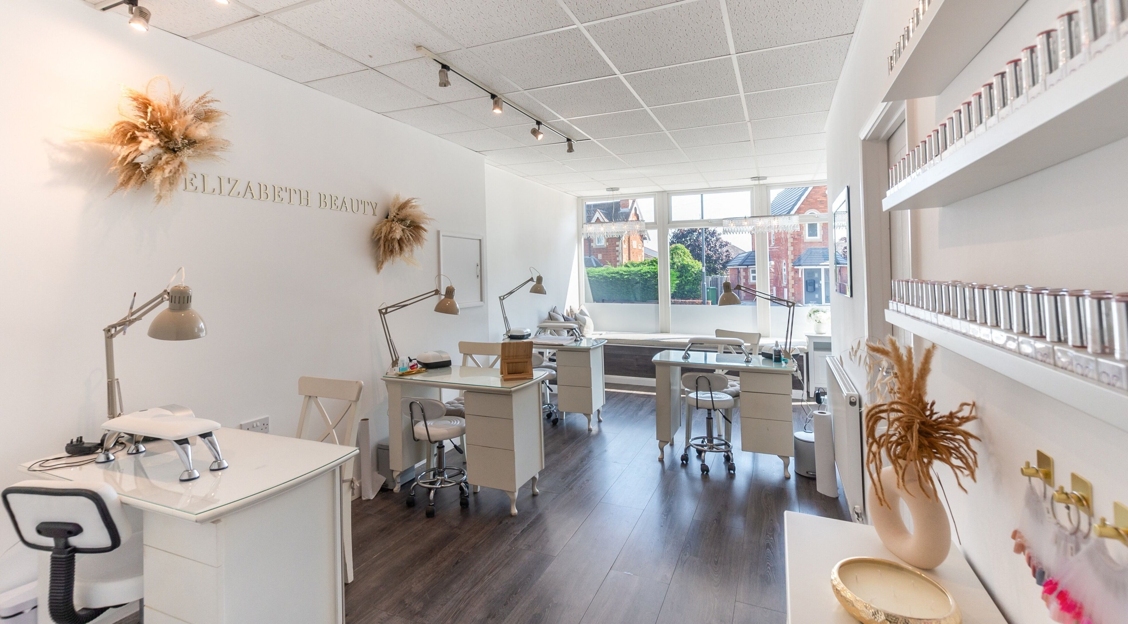 Bright and elegant interior of Elizabeth Beauty in Rugby, England, GB showcasing modern beauty workstations.
