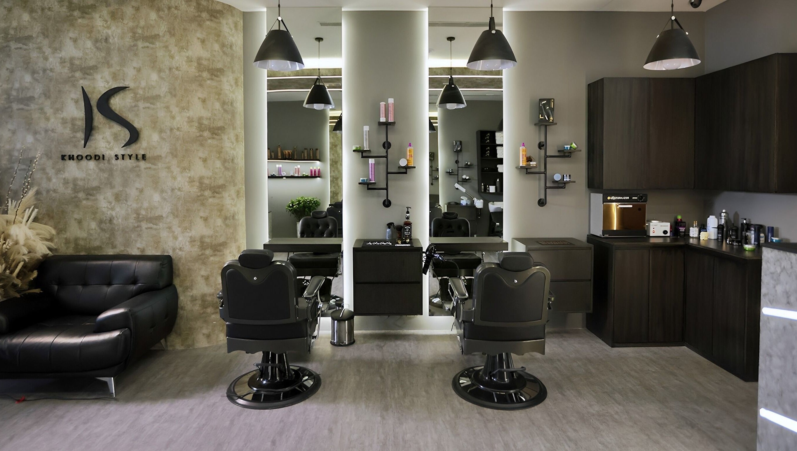 Stylish interior of Khoodi Style Gents Salon in Dubai, Dubai, AE featuring modern barber chairs and decor.