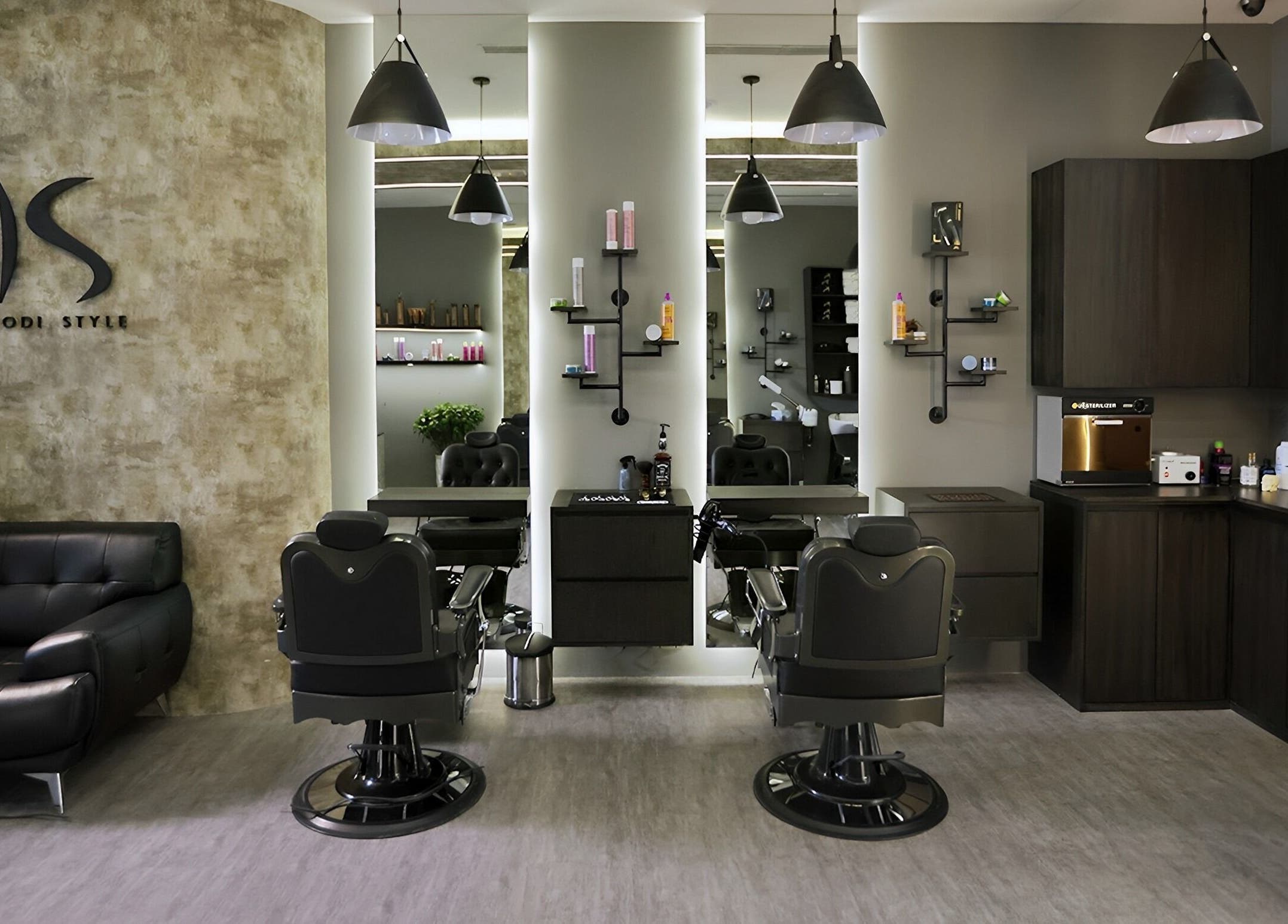 Stylish interior of Khoodi Style Gents Salon in Dubai, Dubai, AE featuring modern barber chairs and decor.