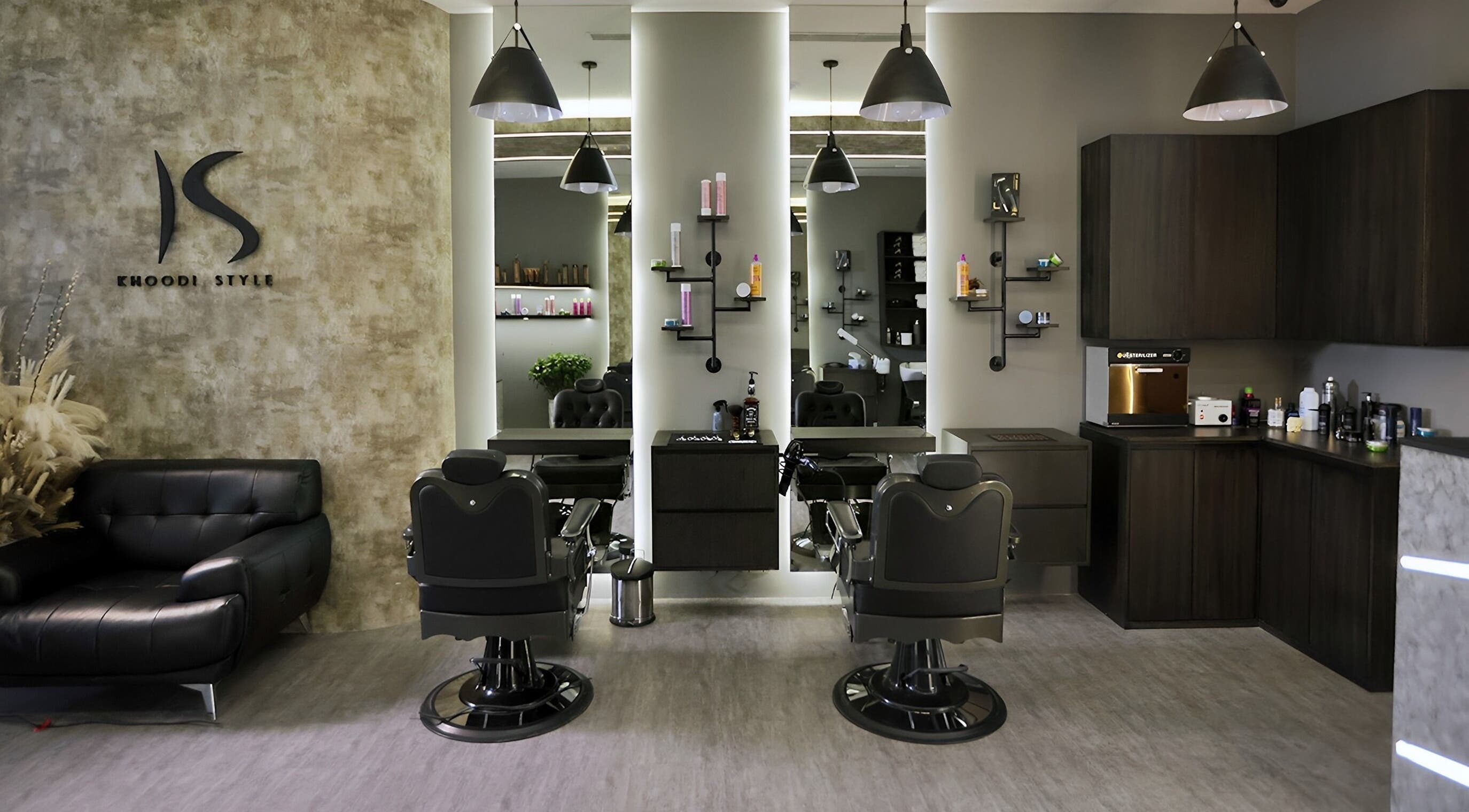 Stylish interior of Khoodi Style Gents Salon in Dubai, Dubai, AE featuring modern barber chairs and decor.