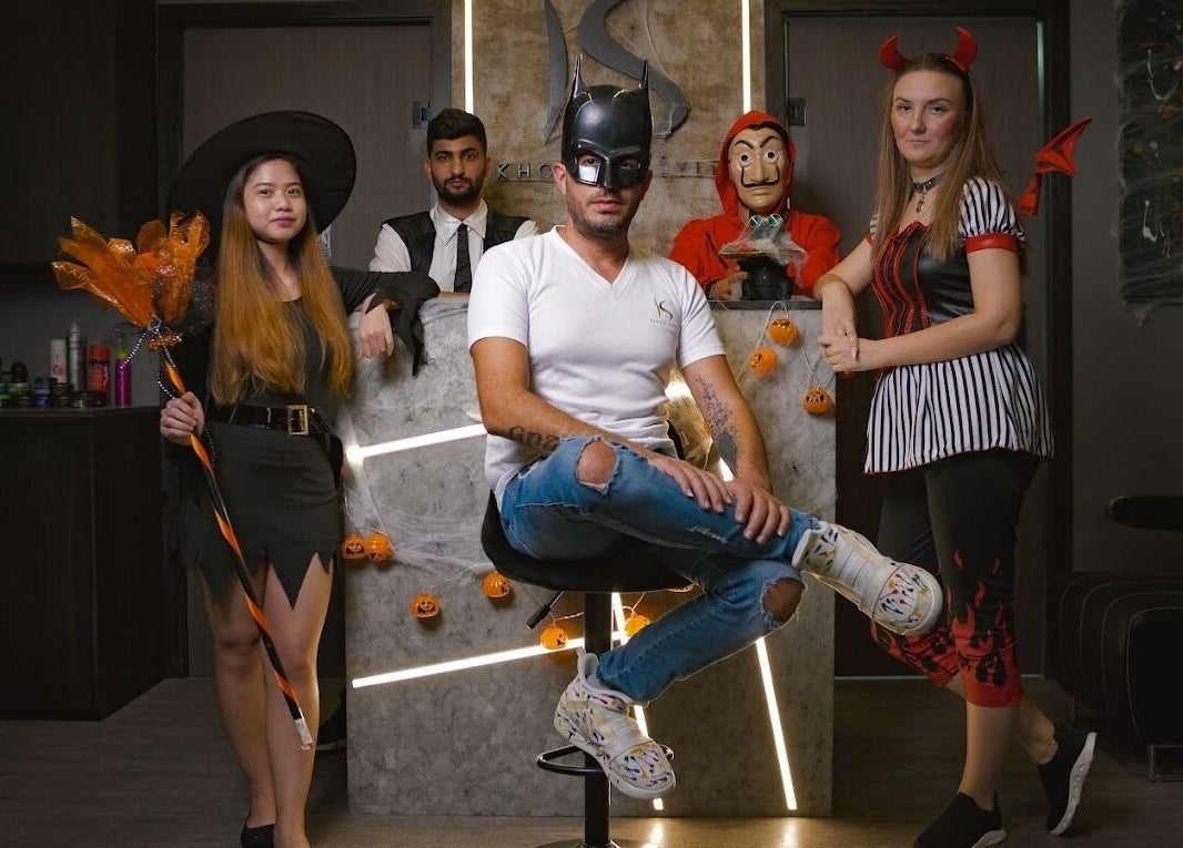 Team in Halloween costumes at Khoodi Style Gents Salon, Dubai, Dubai, AE, showcasing festive creativity.