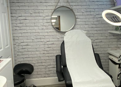 Elegant treatment room at NS Skin Clinic, Hazel Grove, England, GB with a modern chair and serene decor.
