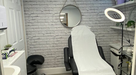 Elegant treatment room at NS Skin Clinic, Hazel Grove, England, GB with a modern chair and serene decor.