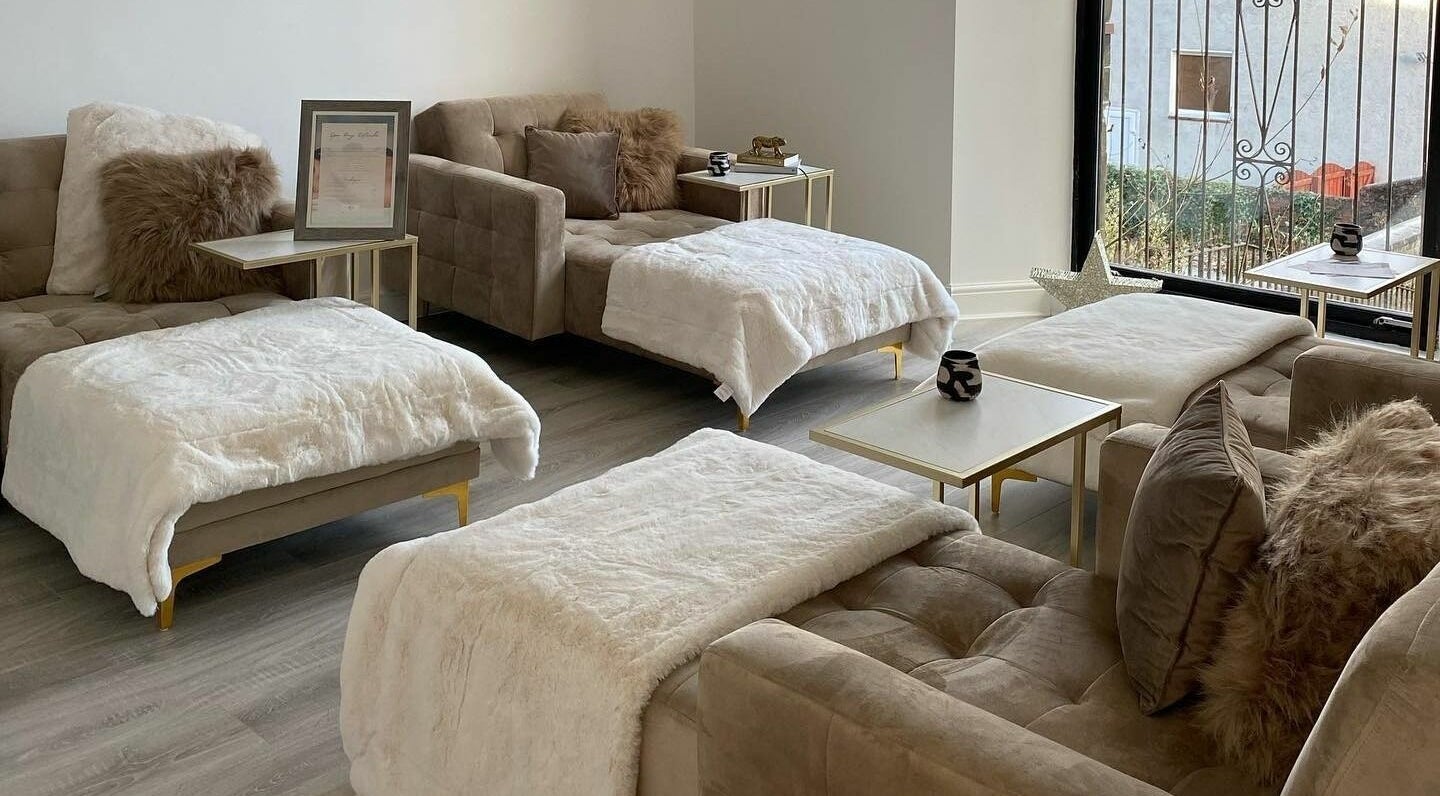 Luxurious lounge area at Rituals Spa & Beauty, Greenock, Scotland, GB with plush seating and warm decor.