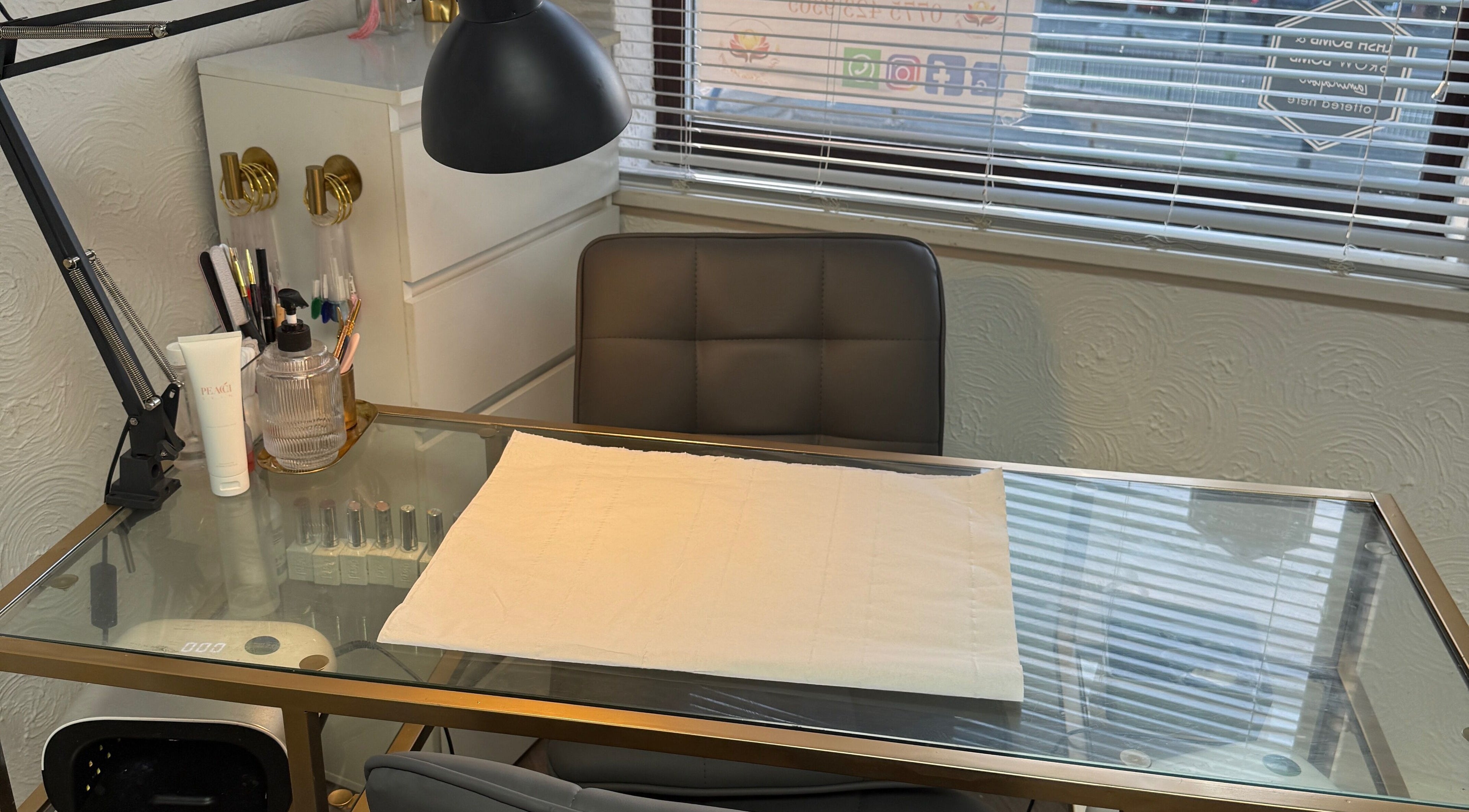 Manicure table at Bloom Beauty Room in Quinton, England, GB. Features tools and sleek decor.