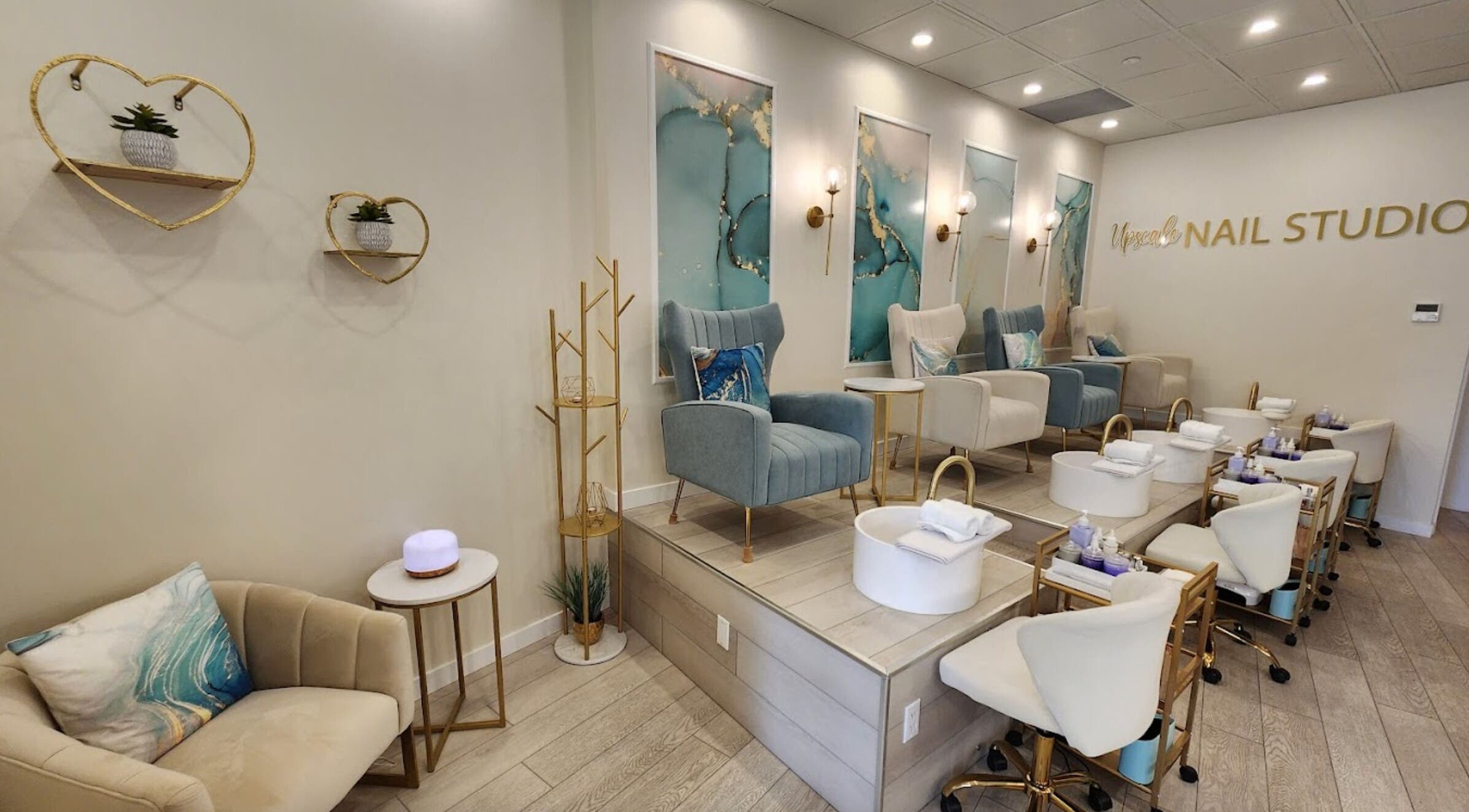 Elegant interior of Upscale Nail Studio in Vancouver, British Columbia, CA, featuring plush chairs and nail stations.