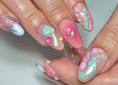 Vibrant, artistic nail design at Jade Saunders Nails, Rugby, England, GB features colorful patterns and embellishments.