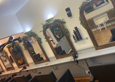 Elegant salon mirrors at Kims Hair in Ferryhill, England, GB, showcasing professional styling stations.