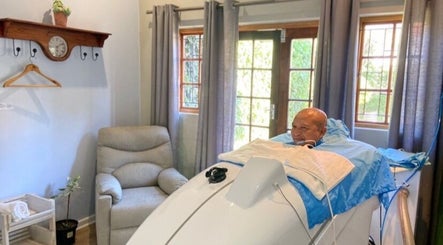 A man enjoys steam therapy at Ozone Clinic Cape Town, Western Cape, ZA in a serene room setting.