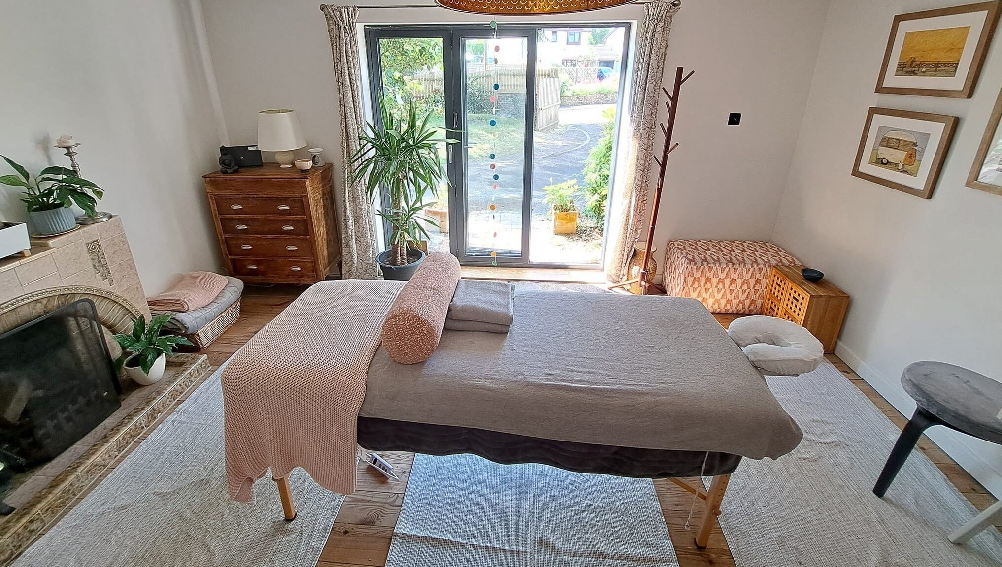 Relaxing massage room at The Cedar Room, Cullompton, England, GB, featuring a cozy setup and natural light.