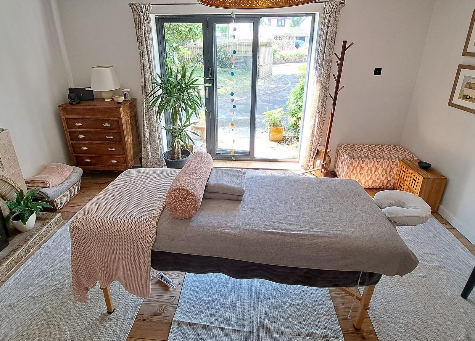 Relaxing massage room at The Cedar Room, Cullompton, England, GB, featuring a cozy setup and natural light.