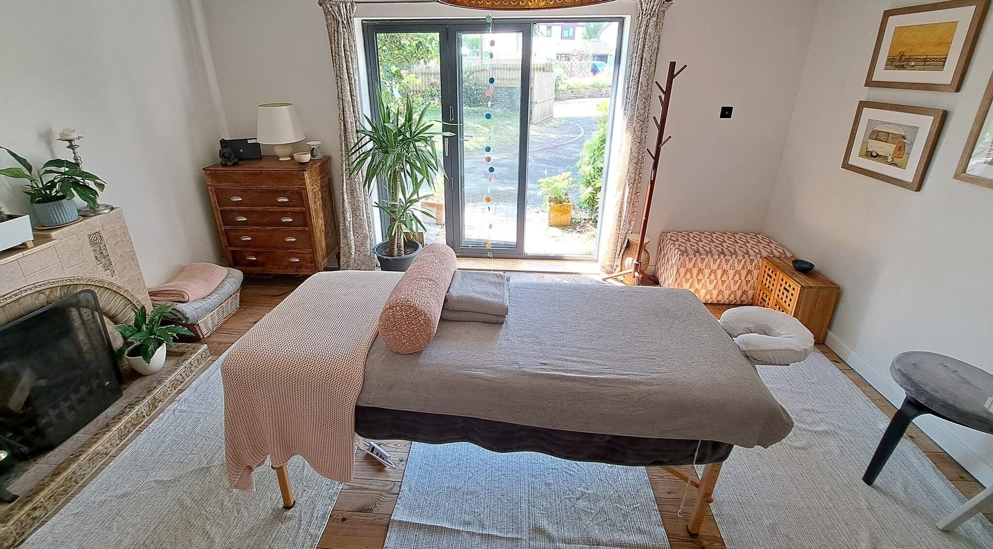 Relaxing massage room at The Cedar Room, Cullompton, England, GB, featuring a cozy setup and natural light.