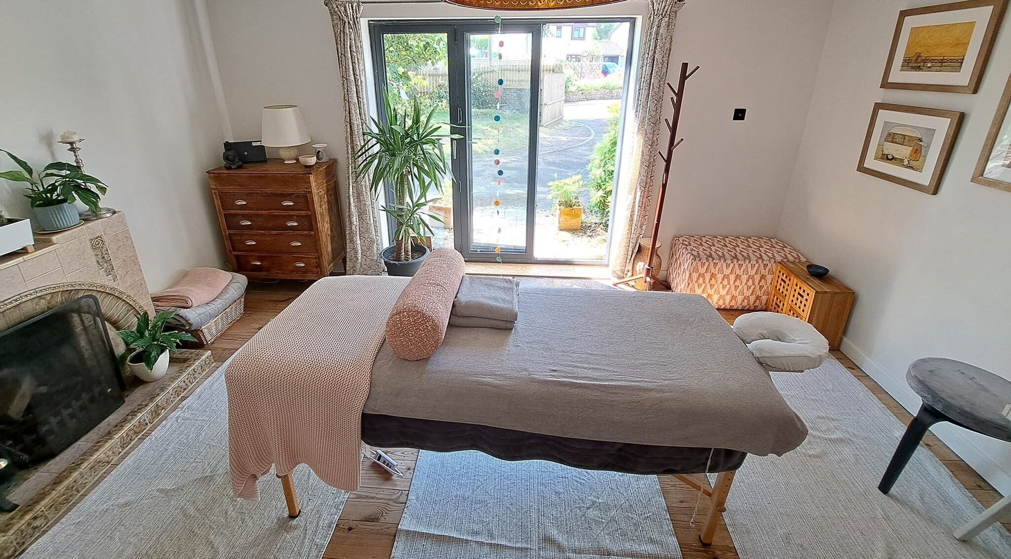 Relaxing massage room at The Cedar Room, Cullompton, England, GB, featuring a cozy setup and natural light.