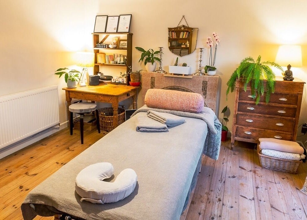 Therapy room with massage bed at The Cedar Room, Cullompton, England, GB. Cozy decor and soft lighting.