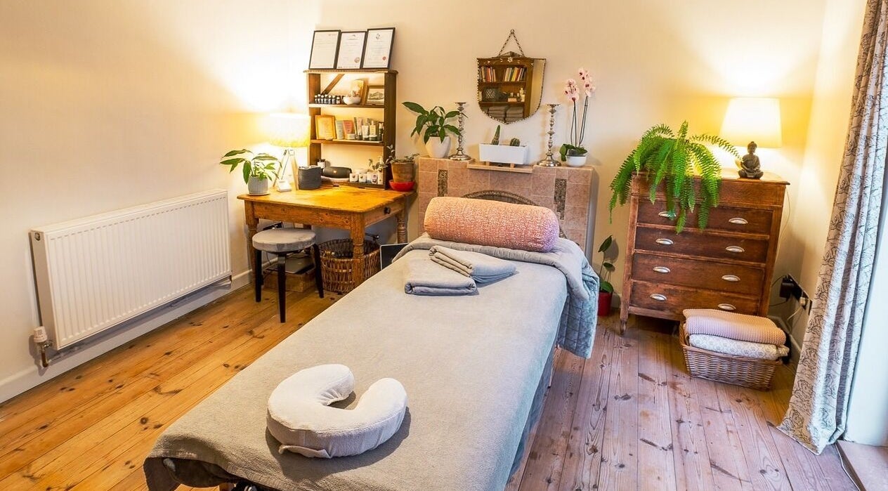Therapy room with massage bed at The Cedar Room, Cullompton, England, GB. Cozy decor and soft lighting.