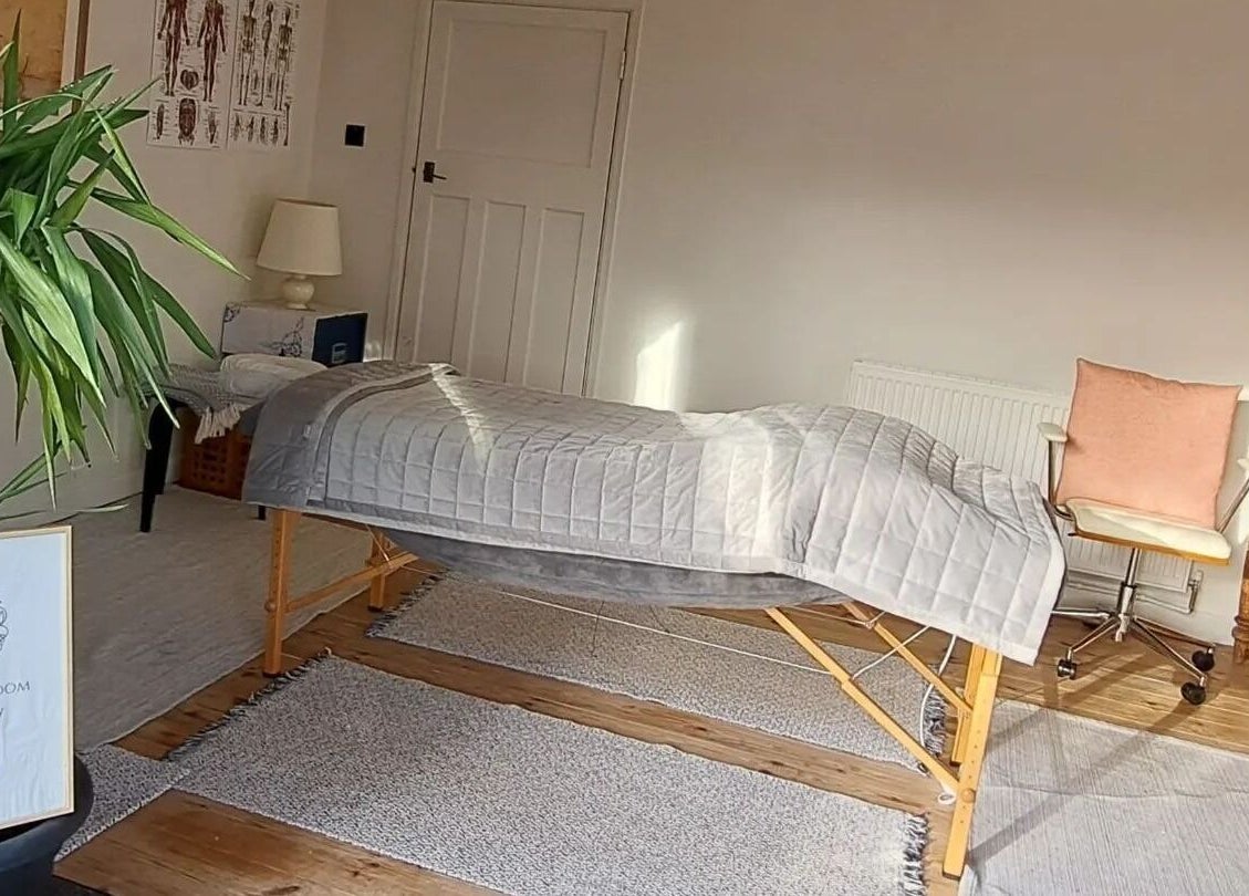 Relaxing massage room at The Cedar Room, Cullompton, England, GB featuring a therapy bed and calming decor.