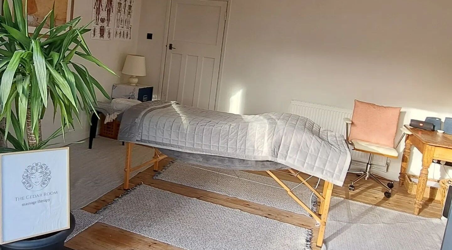 Relaxing massage room at The Cedar Room, Cullompton, England, GB featuring a therapy bed and calming decor.