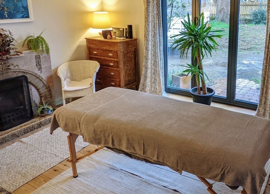 Cozy massage room at The Cedar Room, Cullompton, England, GB, with ambient lighting and a peaceful atmosphere.