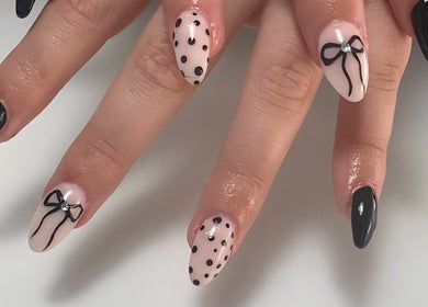 Elegant polka dot and bow nail art at Black and Purple Pride of Royalty at Hair Design Salon, Roodepoort, Gauteng, ZA.