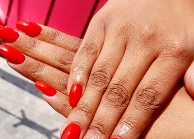 Glossy red manicured nails at Black and Purple Pride of Royalty at Hair Design Salon, Roodepoort, Gauteng, ZA.