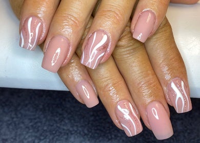 Stylish nail art at Nail Nook in Bingley, England, GB. Delicate pink and white design beautifully showcased.