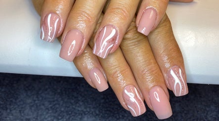 Stylish nail art at Nail Nook in Bingley, England, GB. Delicate pink and white design beautifully showcased.