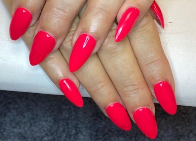 Bright red manicured nails at Nail Nook, Bingley, England, GB, showcasing expert nail artistry.