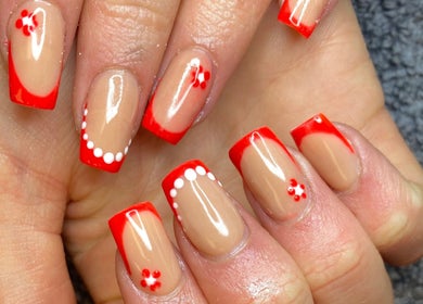 Chic red French manicure with floral design at Nail Nook, Bingley, England, GB.