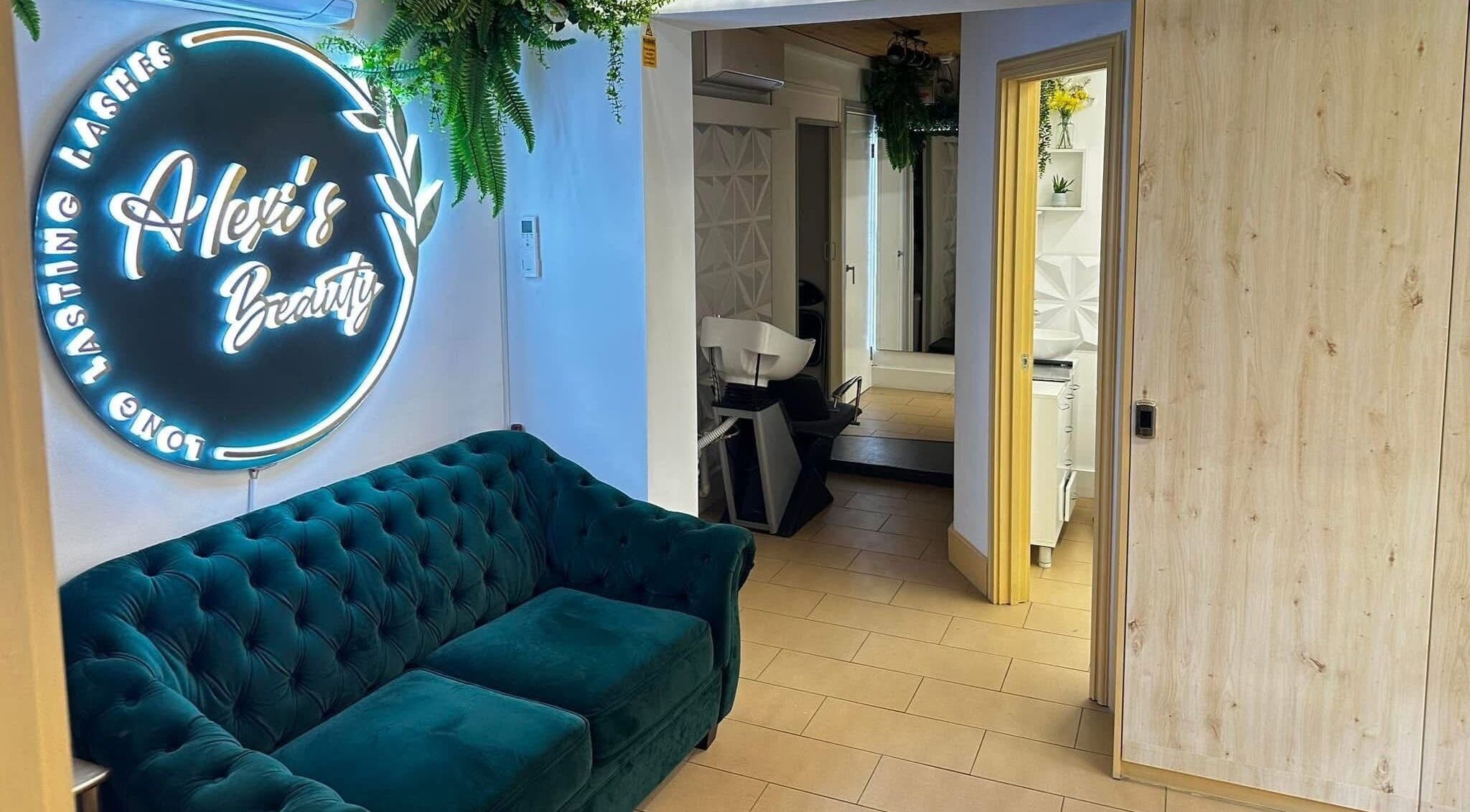 Elegant lounge at ABeauty's, Alexis in London, England, GB with stylish decor and a plush green couch.