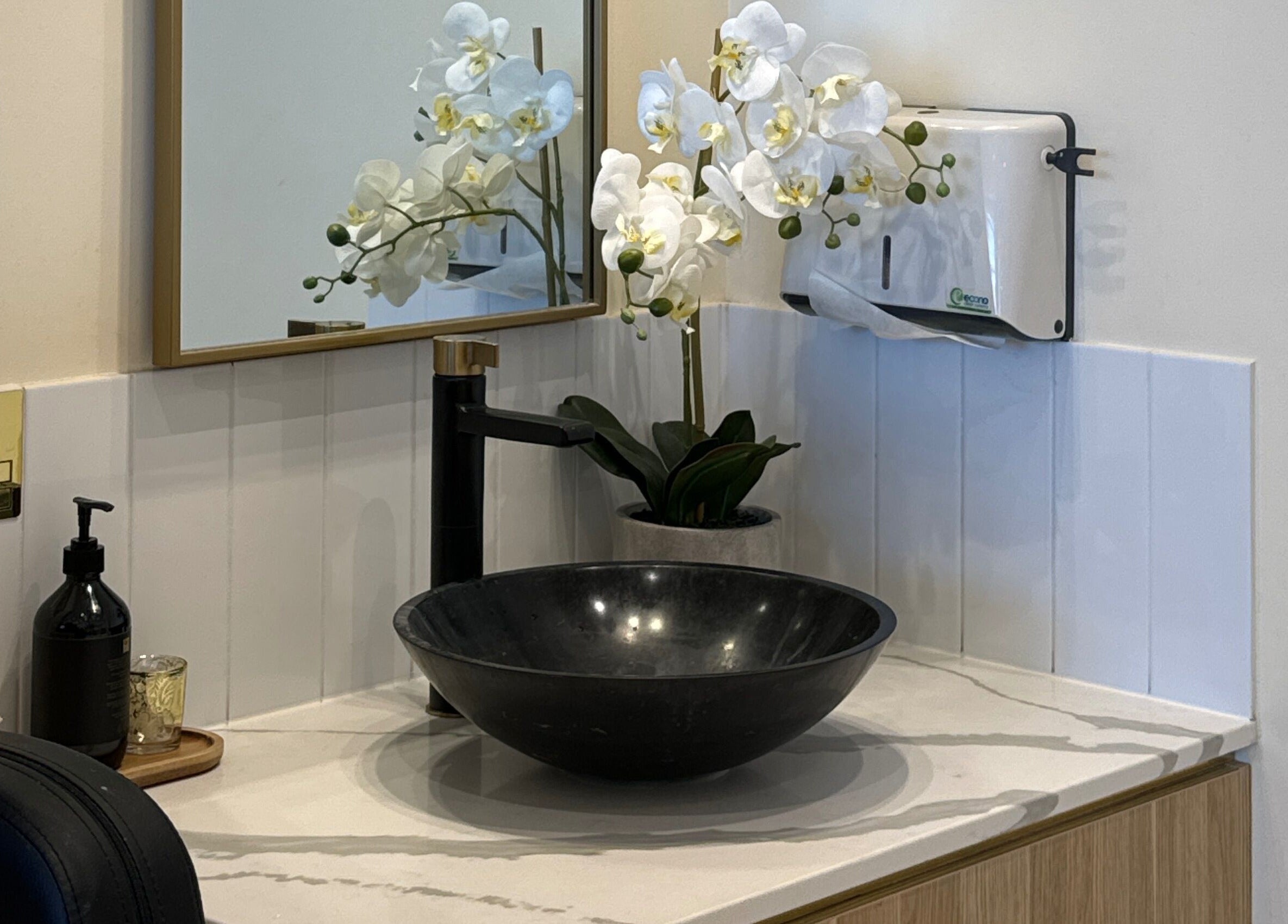Elegant sink area at iNail Spa, Mentone, Victoria, AU with orchid decor and modern fixtures.