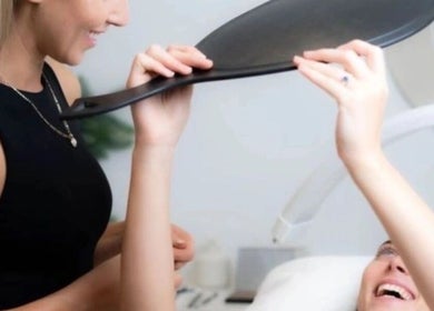 Client holds mirror to admire brows at House of Terri Brows, Rozelle, New South Wales, AU.