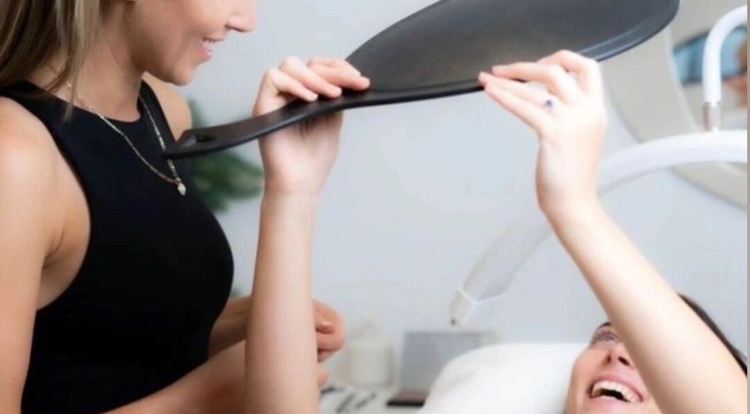 Client admiring brows in mirror at House of Terri Brows, Rozelle, New South Wales, AU.