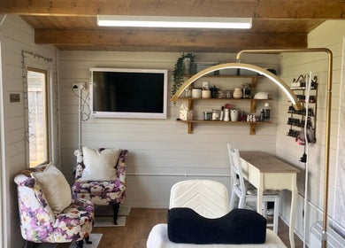 Charming interior of Holly Wood semi permanent make up & beauty in Chichester, England, GB with floral decor.