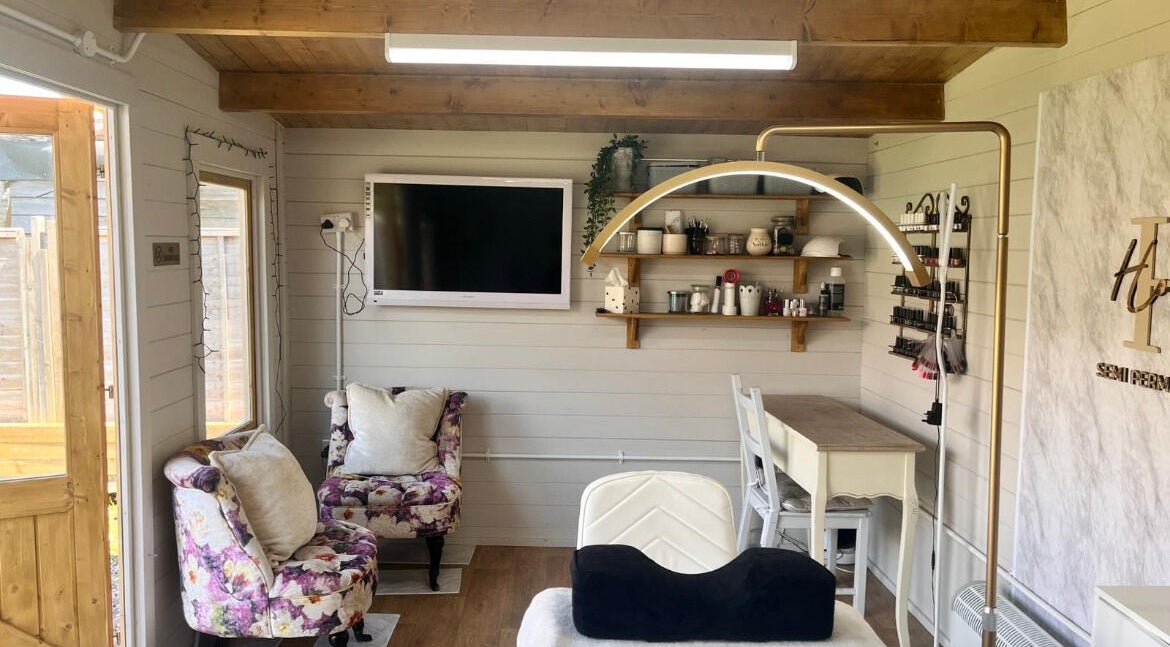 Charming interior of Holly Wood semi permanent make up & beauty in Chichester, England, GB with floral decor.