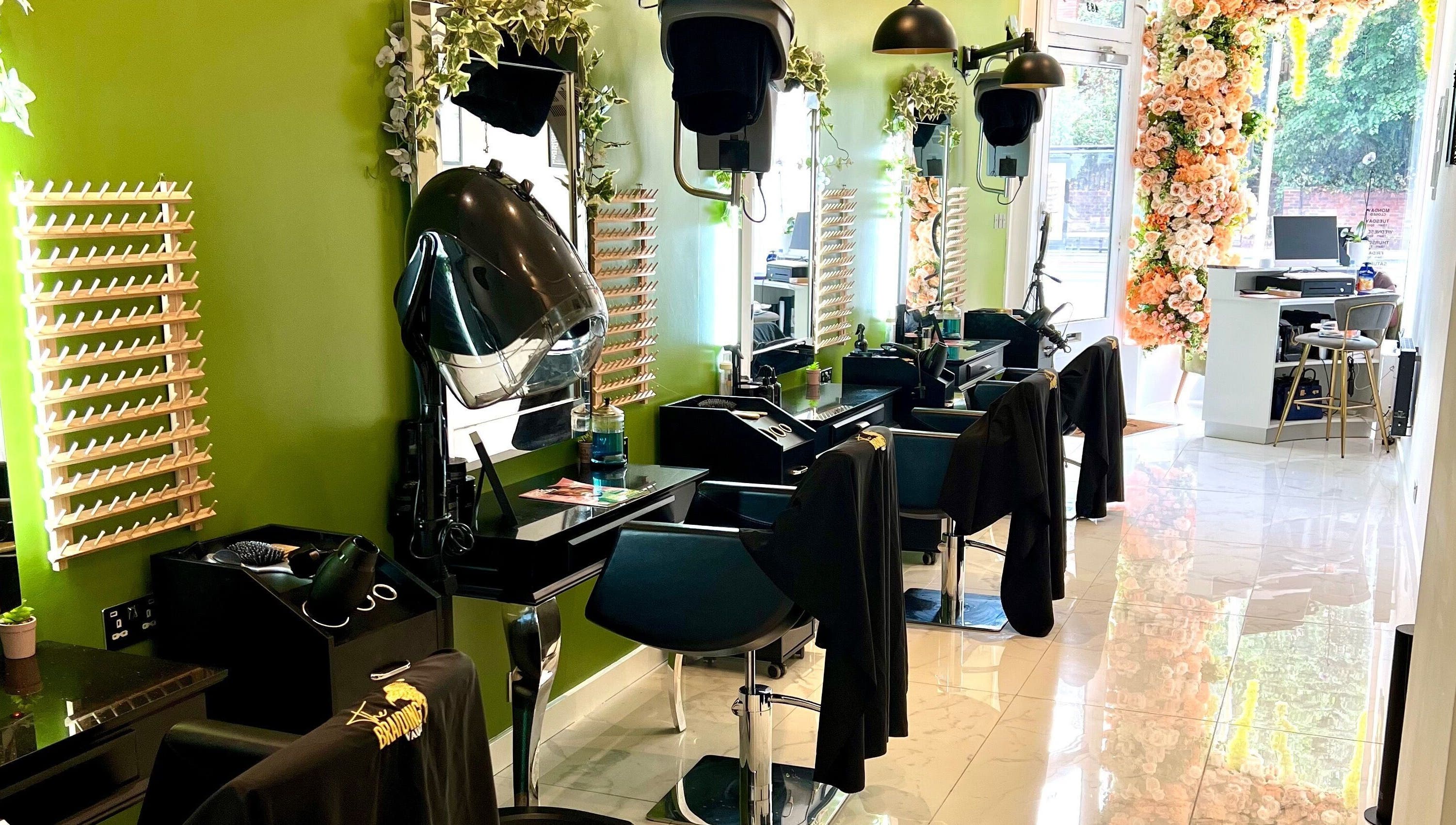 The Braiding Vault Uk in London, England, GB - a stylish, green-themed salon interior with floral decorations.