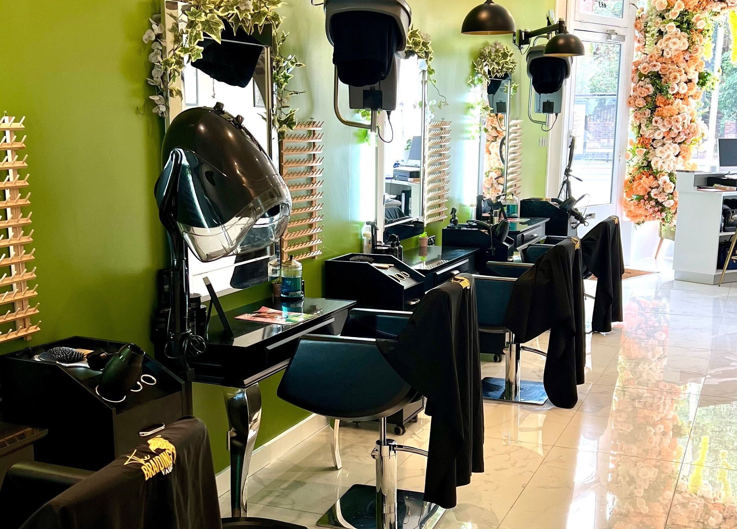 The Braiding Vault Uk in London, England, GB - a stylish, green-themed salon interior with floral decorations.