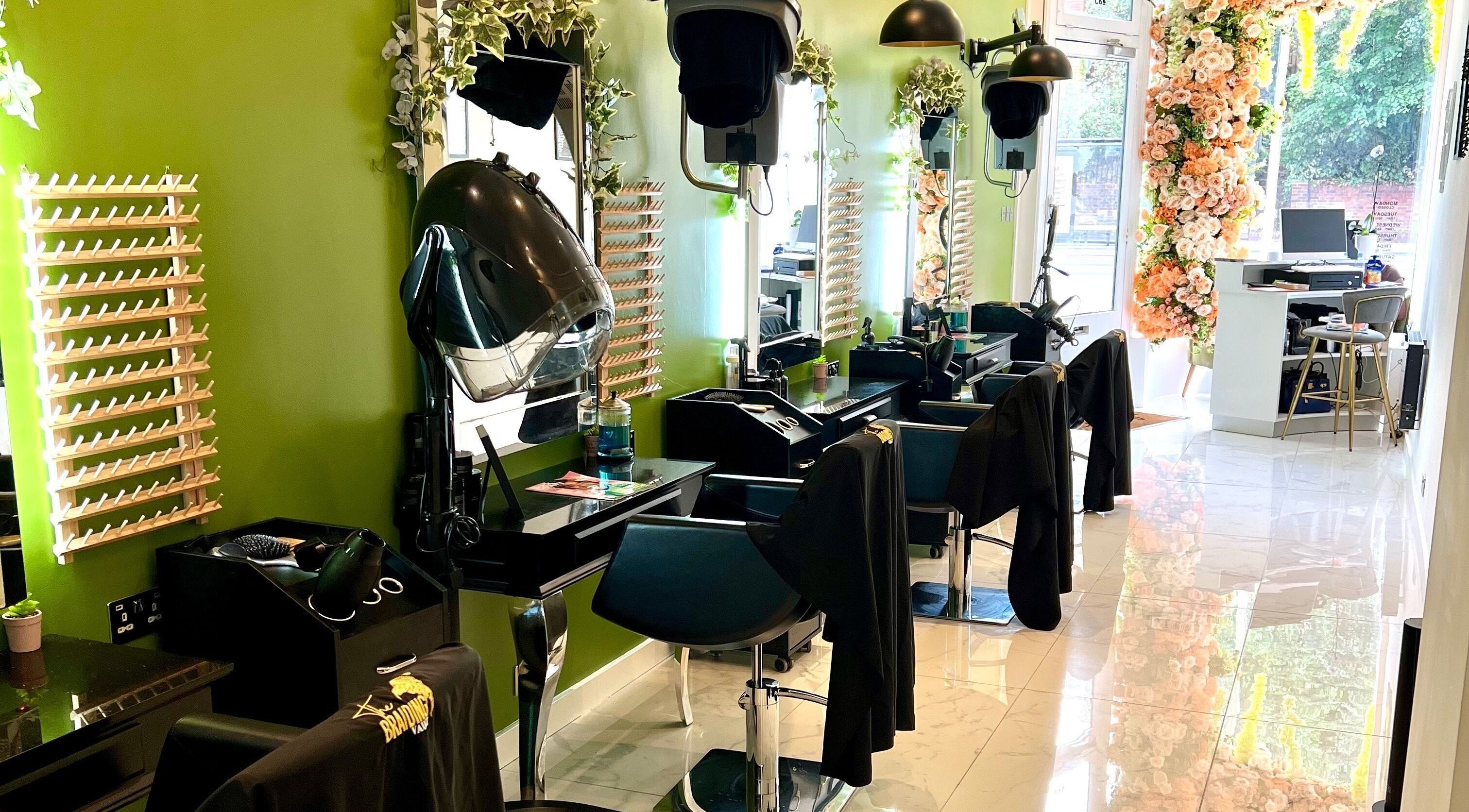 The Braiding Vault Uk in London, England, GB - a stylish, green-themed salon interior with floral decorations.