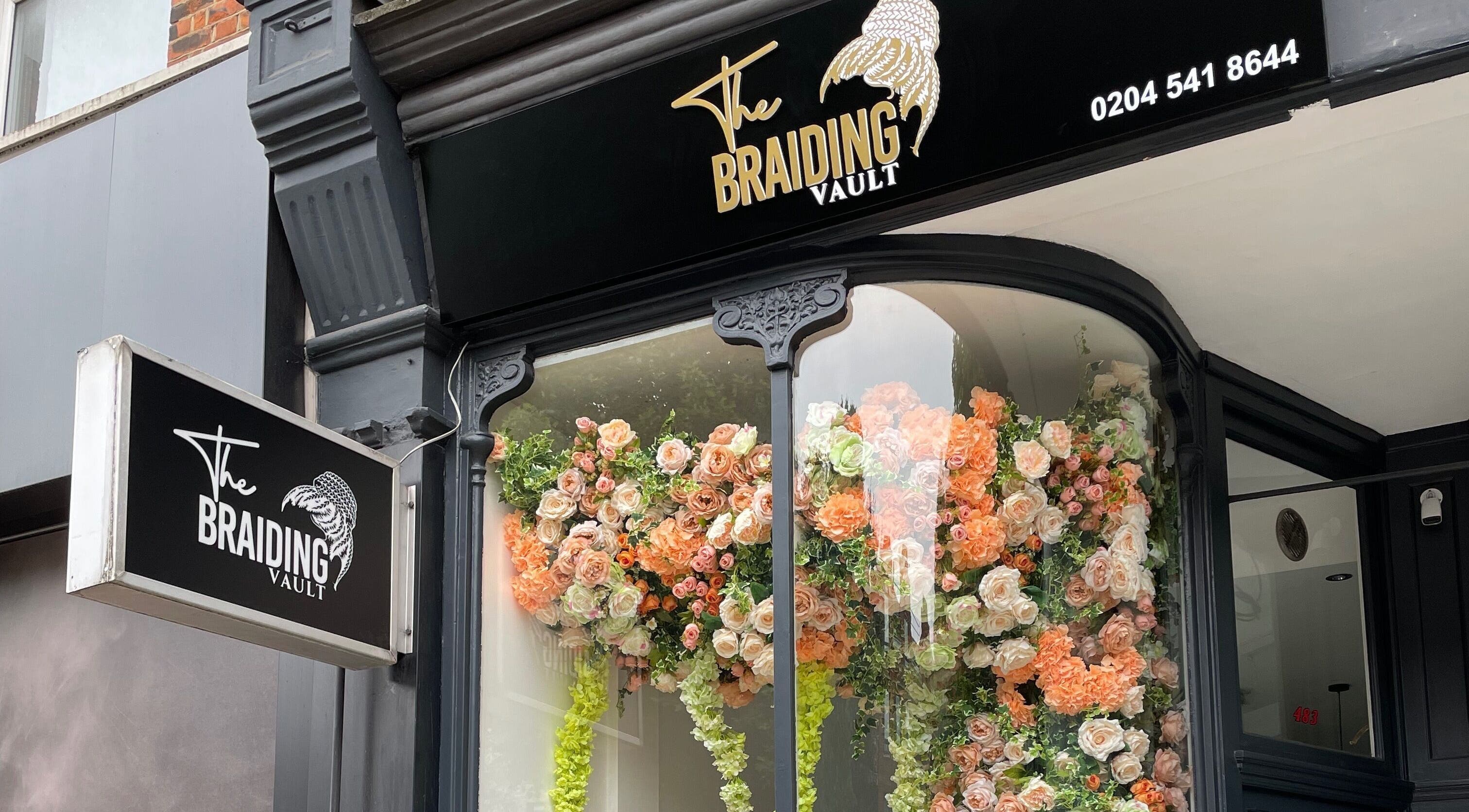 The Braiding Vault Uk storefront with vibrant floral display in London, England, GB.
