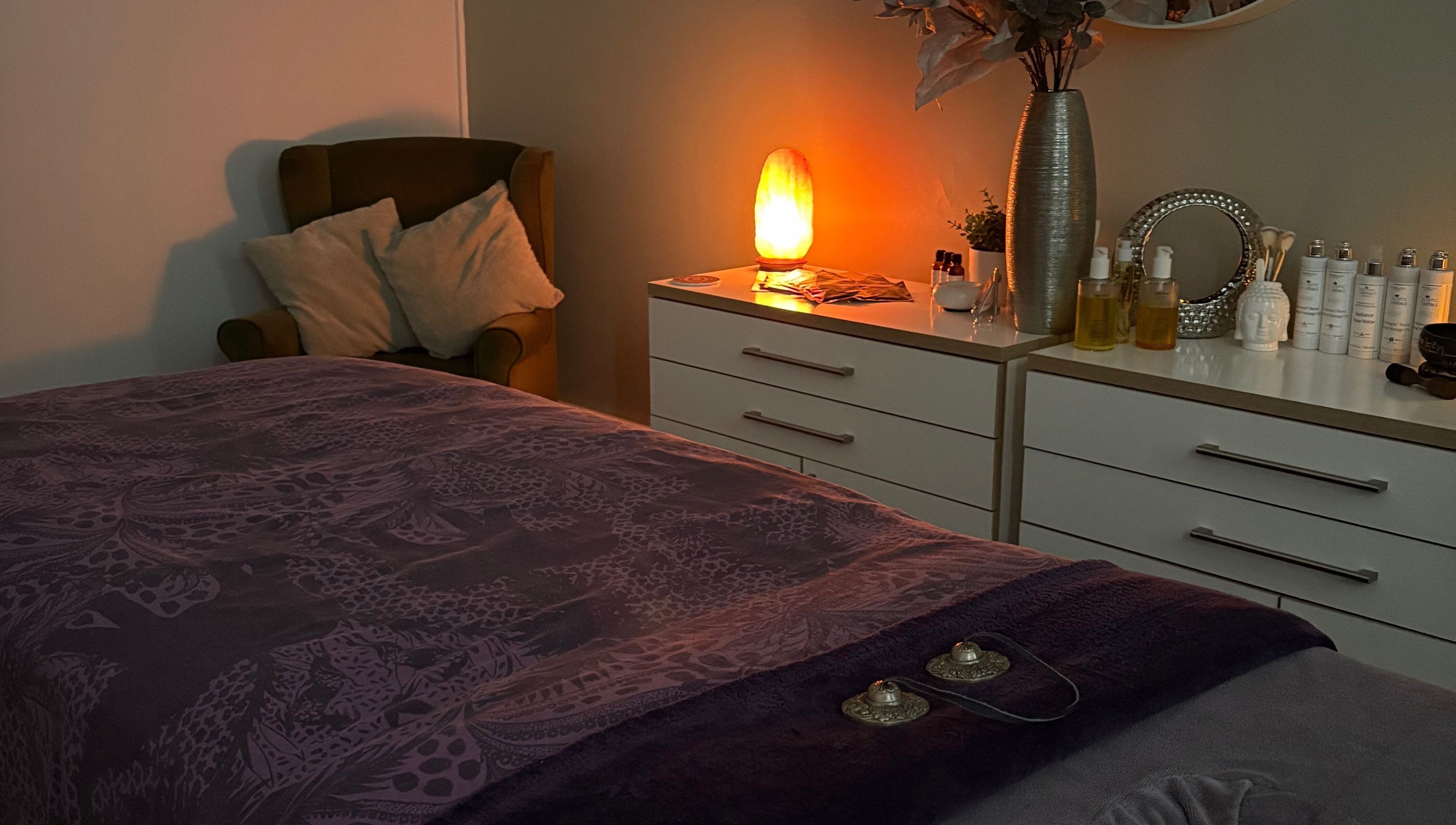 Cozy treatment room at Tranquility Holistic, Sarisbury Green, England, with warm lighting and plush décor.